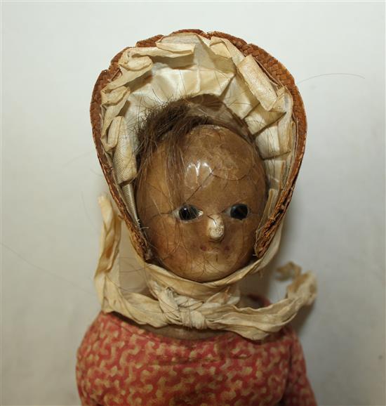 An early 19th century poured wax head and shoulder doll, 14in.